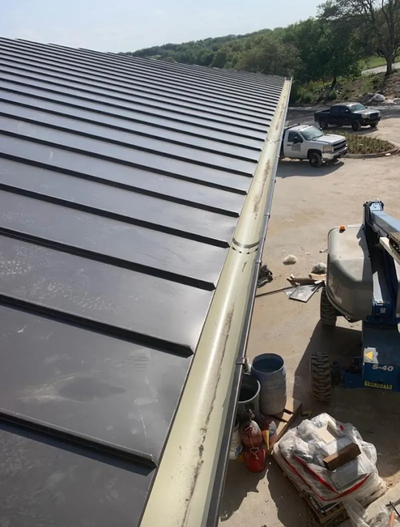 Standing seam panel and gutter detail on a metal roofing jobsite in Sidney